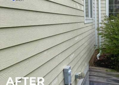 Home exterior siding after power washing, showing clean, bright vinyl siding near a window, utility meter, and landscaping, labeled “After Power Washing” with Central Power Wash logo.